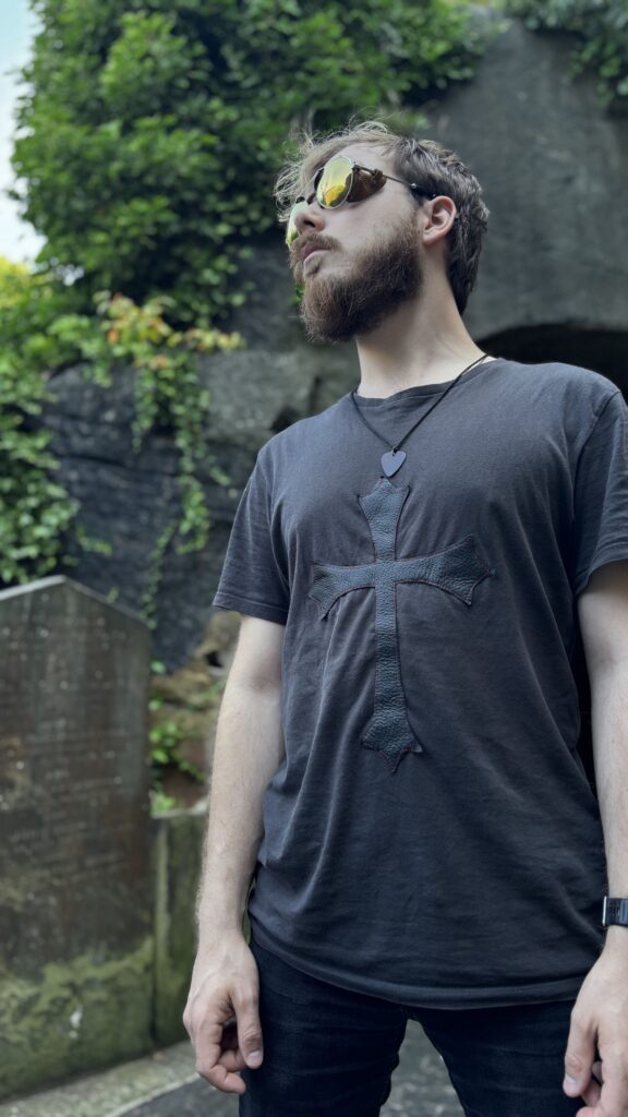 Goth cross - black t-shirt with a large leather gothic cross, worn